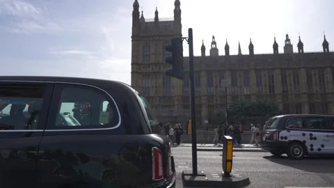 Slow motion view of traffic and pedestrians passing on Westminster Bridge Stock Footage 260022024