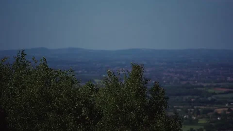 Slow-motion view of tree leaves and Worcestershire from the Malvern Hills Stock Footage 130911153