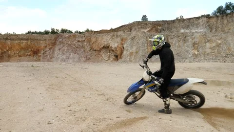 Slow motion view of tricks on a motorcycle in a quarry in Slovakia Stock-Footage 141929572
