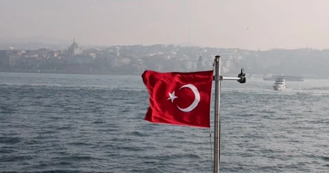 Slow motion view of the Turkish flag on a ship cruising the Istanbul Bosphorus Stock Footage 300170308