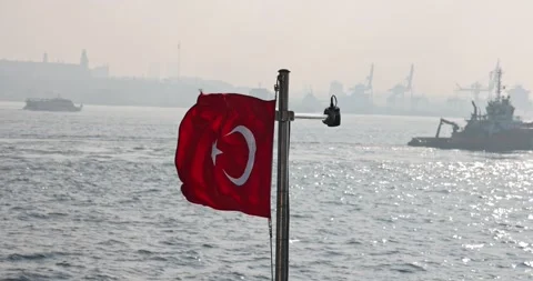 Slow motion view of the Turkish flag on a ship cruising the Istanbul Bosphorus Stock Footage 300171630