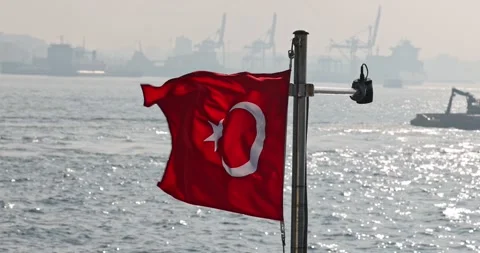 Slow motion view of the Turkish flag on a ship cruising the Istanbul Bosphorus Stock Footage 300172608