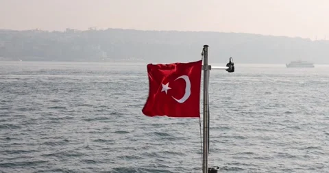 Slow motion view of the Turkish flag on a ship cruising the Istanbul Bosphorus Stock Footage 300172826