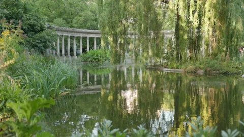 Slow Motion View of Water Ripples and Ancient Columns Reflecting in a Tranquil P Stock Footage 340477047