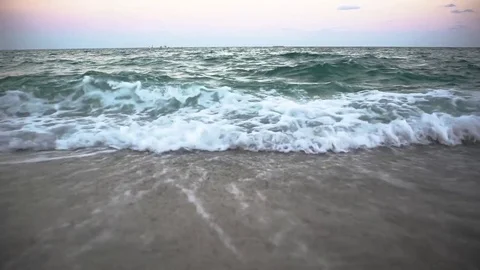 Slow motion view of waves rolling onto the beach Stock Footage
