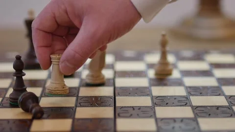 Drawing on white background of someone moving a pawn on a chess board with  impact effects