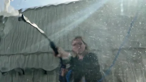 Slow Motion View of Woman Using Pressure Washer at Self-Service Car Wash Stock Footage 327650778