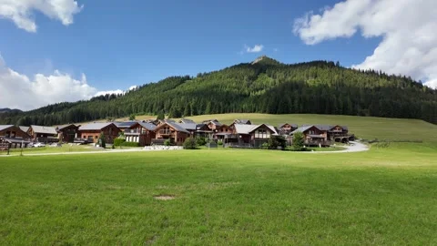 Slow motion view of a wooden alpine chalet resort in the mountains Stock Footage 344890271