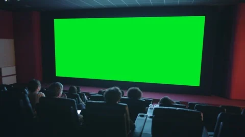 Slow motion of viewers clapping hands looking at green chroma key cinema screen Video stock 114758422