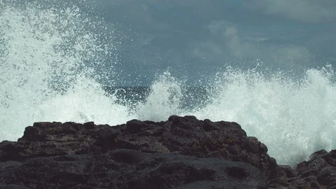 SLOW MOTION: Violent ocean wave splashes across the empty rocky beach in Chile. Stock Footage 91223081