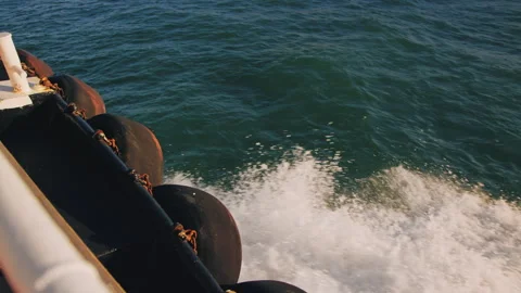 Slow motion wake and surf created by moving boat, seen from deck Stock Footage 242832632