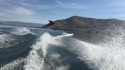 SLOW MOTION: Wakeboarding Grab over the wake Stock Footage 54708765