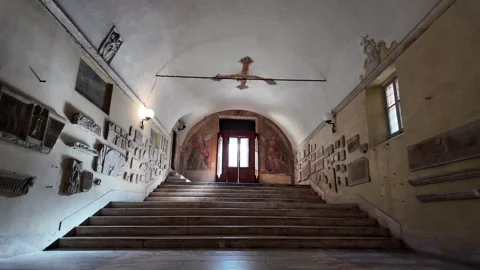 Slow motion walk along a corridor and stairs in Sant'Agnese fuori le mura Stock Footage 333917947