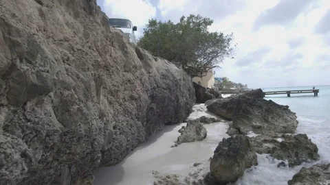 Slow motion walk forward on the rocky beach Видео 74024576