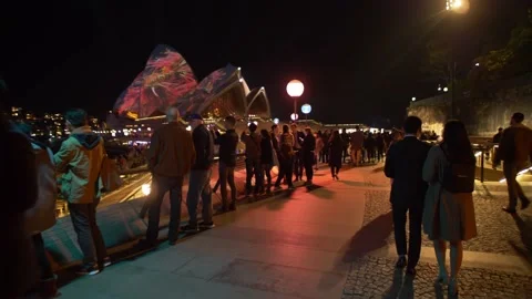 Slow motion walk through crowds at Sydney Opera House during Vivid 4K Video stock 165708267