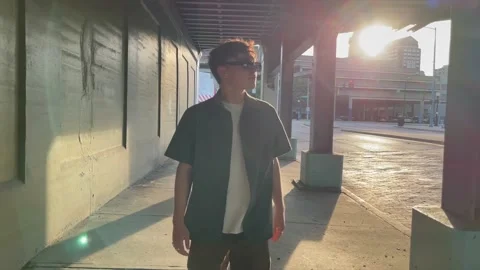 Slow motion walking shot of young Native American man walking through urban Stock Footage 156366919