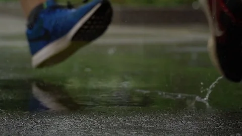 Slow Motion walking through rain puddle Stock Footage 87094289