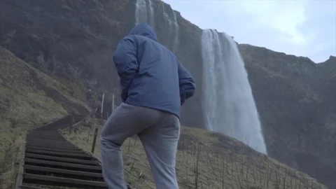 SLOW MOTION - Walking up Waterfall Steps - Rainy Day Stock Footage 129458297