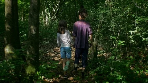 Slow motion walking in the woods Stock Footage 76778957
