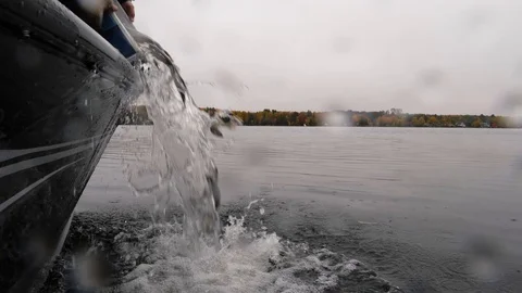 Slow motion of Walleye released from a small boat and dumped into a cold Stock Footage 97719339