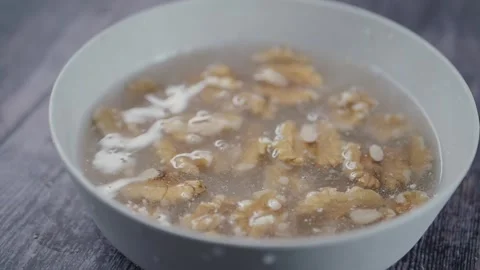 Slow motion of walnuts drops in a bowl of water Stock Footage 336882495