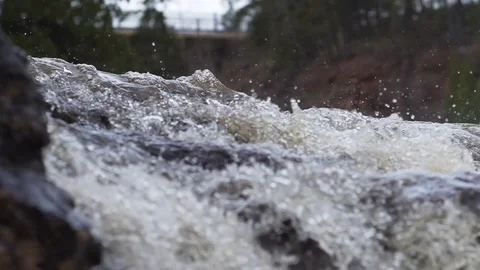 Slow motion water and tiny drops trickle over beautiful waterfall in river Stock Footage 116180280