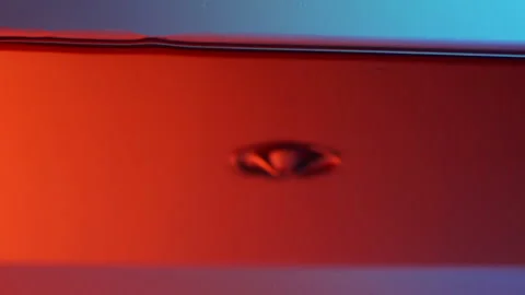 Slow motion of water drop with circles in neon water surface as abstract Stock Footage 130540065