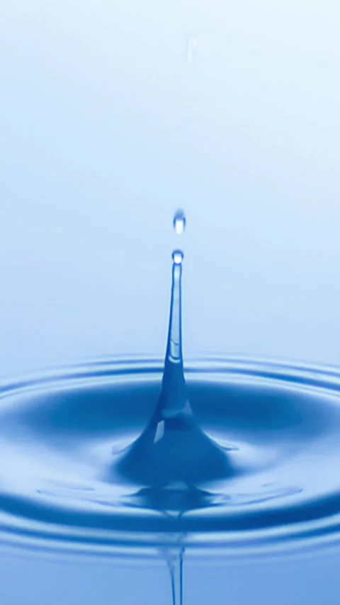 Slow Motion Water drop splash into calm water - shot with ultra high speed .. Stock Footage 254491792