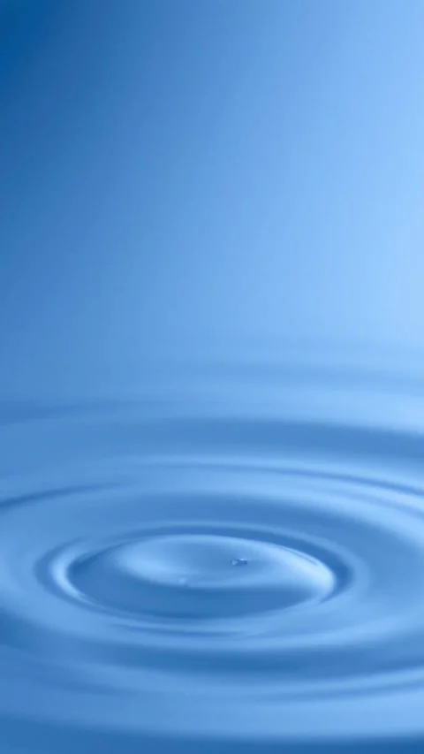 Slow Motion Water drop splash into calm water - shot with ultra high speed .. Stock Footage 258960302