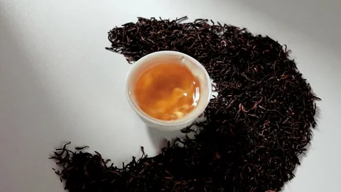Slow Motion Water Droplet Falling into Cup of Hot Black Tea Stock Footage 341926389