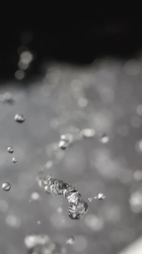 Slow-motion water droplets drip from rocks, each crystal-clear drop distinc.. Stock Footage 291869098