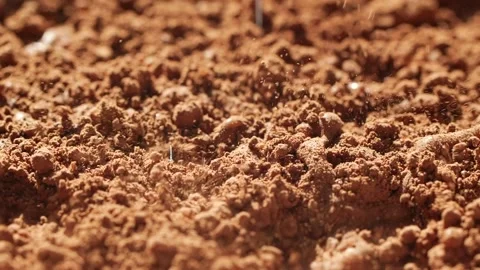 Slow motion of water drops falling and splashing onto ground coffee, cocoa beans Stock Footage 141749380