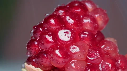 Slow motion of water drops falling on grains of fresh ripe pomegranate Stock Footage 170396302
