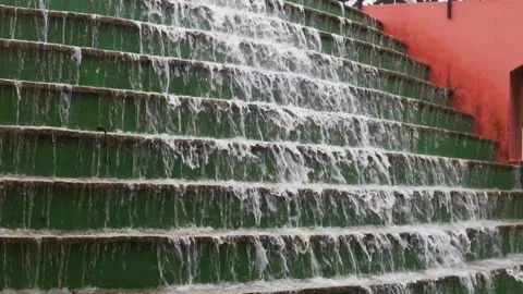 Slow motion of water falling in an artificial waterfall in a public park Video stock 276427082