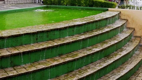 Slow motion of water falling in an artificial waterfall in a public park Stock Footage 276427797