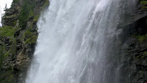 Slow motion of water falling down from big waterfall in alps nature background Stock Footage 292811860