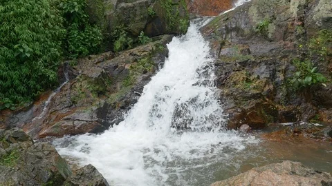 Slow motion water falling over rocks Stock Footage 92536251