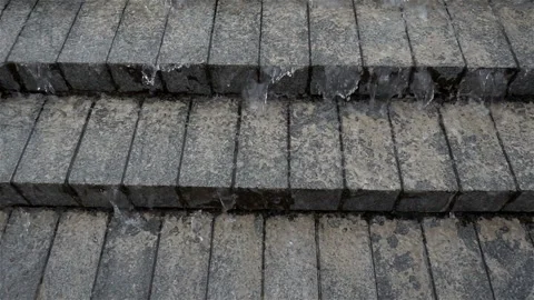 Slow motion of water flow down the stone stairs Stock Footage 119757788