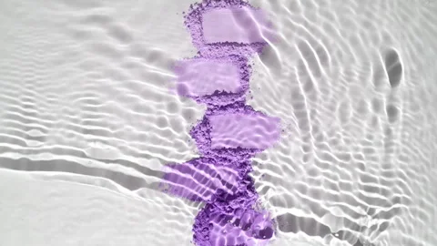 Slow-motion water flow over violet powder heaps Stock Footage 341664869