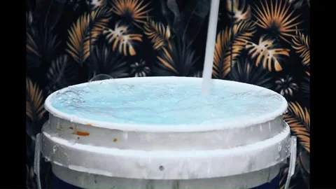 Slow motion of water flowing and spilling in a barrel Stock Footage 302984712