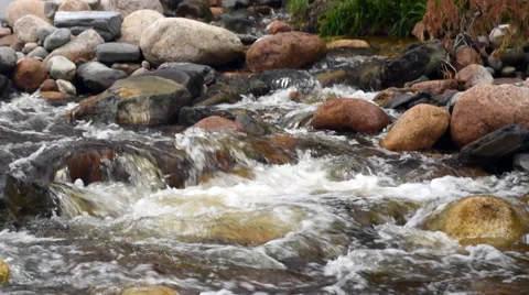 Slow motion water flowing over rocks in mountain stream Stock Footage 68055053