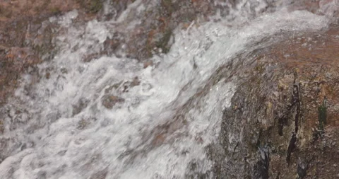 Slow Motion Water Flowing Over Rocky Surface in Nature Stock Footage 302963360