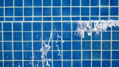 Slow motion water flowing overflow blue swimming pool Stock Footage 88337121