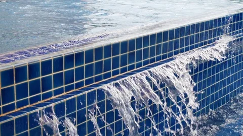 Slow motion water flowing overflow blue swimming pool Stock Footage 89262672