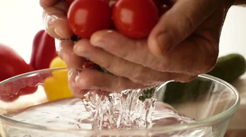 Slow motion water flows from the cherry tomatoes Stock-Footage 68660682