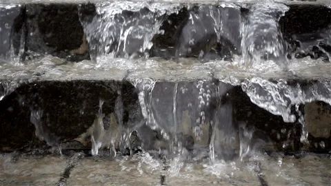 Slow motion water flows flowing down a staircase. Stock Footage 120834163