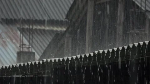 Slow motion, water flows from the gaps in the asbestos roof during heavy rain Stock Footage 309528284
