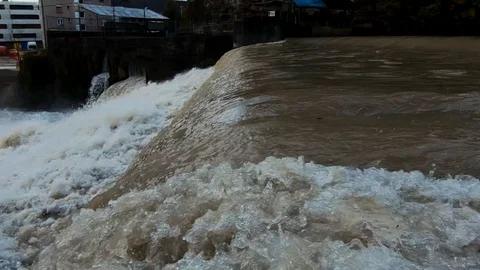 Slow motion water flows on man made river cascades after autumn rainfall flood Stock Footage 120528462