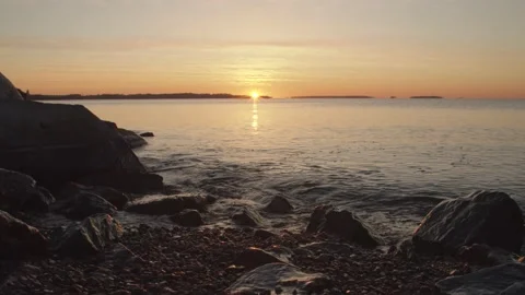 Slow motion water lapping at rocks at sunrise in Helsinki, Finland Stock Footage 146263085