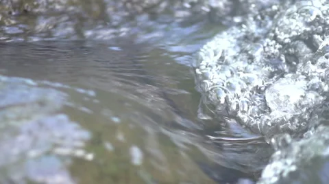 Slow Motion Water over River Stones 240fps 動画素材 45992688